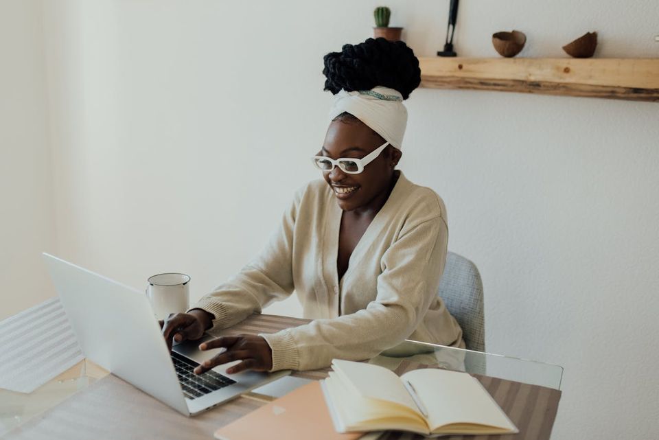 A participant writing code at a bright desk