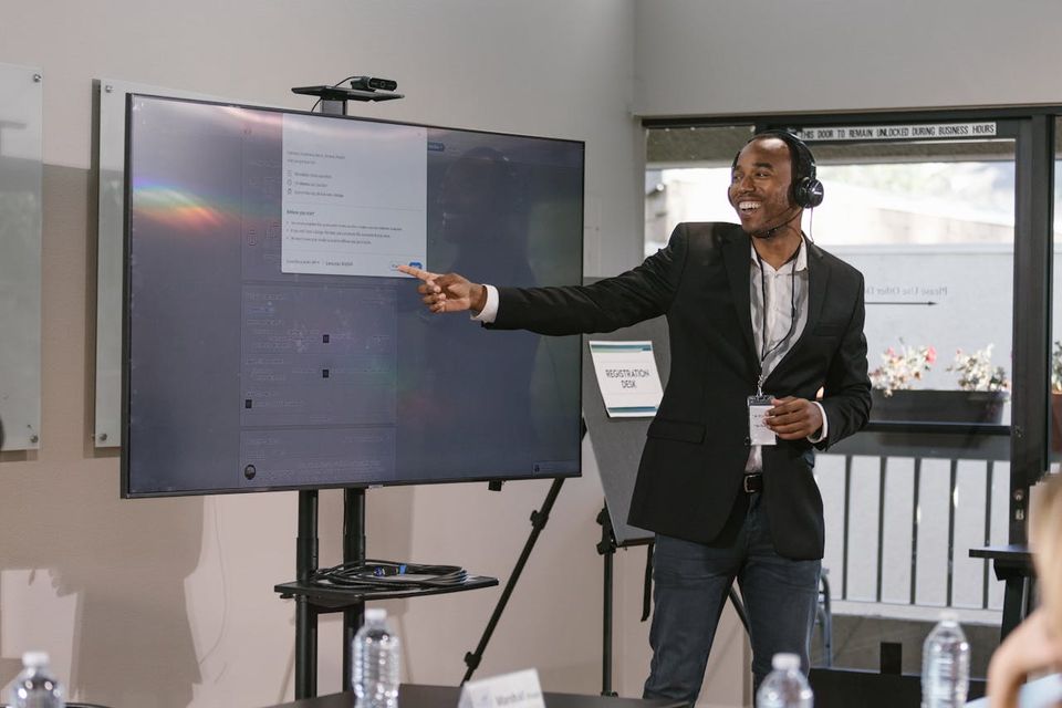 A BuildReach mentor leading a session in front of a screen