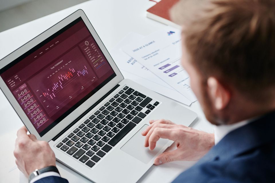 A professional reviewing a process dashboard on a laptop